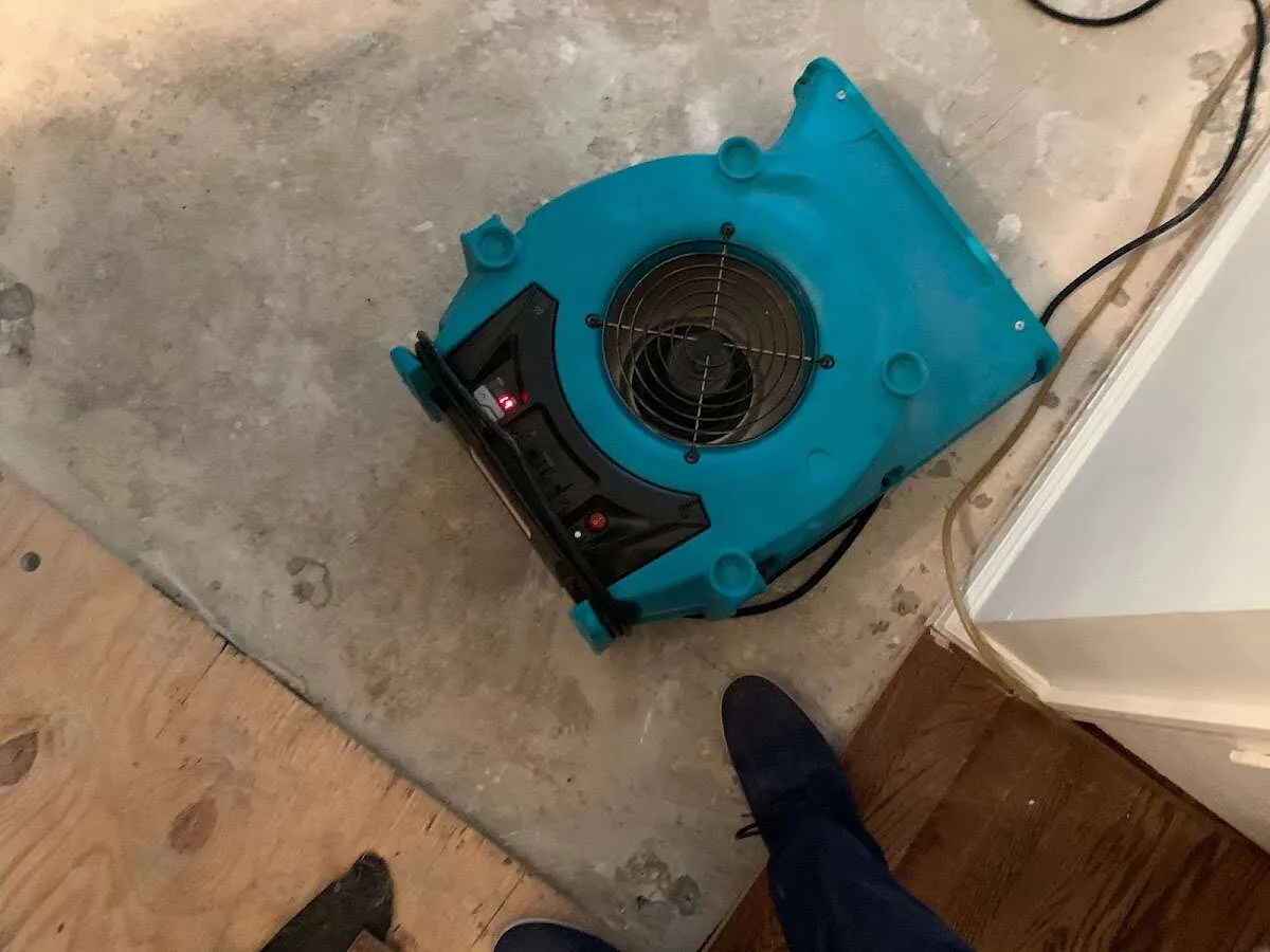 Air mover drying subfloor during Commercial Water Damage Restoration in Morrisville